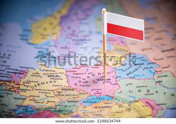 Poland marked with a flag\
on the map