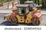 Poland Ostrowiec Swietokrzyski August 13, 2024 11:05 a.m. DYNAPAC road rollers compact the final layer of asphalt. . Construction works are close to the completion of the rebuilt road in the city.
