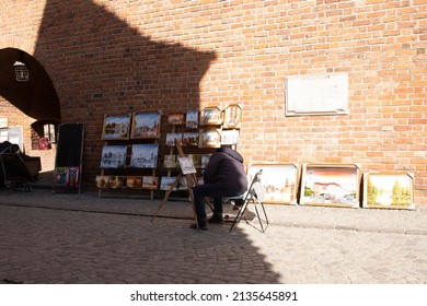 Poland, Warsaw, 12 March 2022. Polish man drawing painting watercolor image picture for show and sale pole people and foreign travelers at Warsaw Barbican