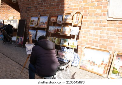 Poland, Warsaw, 12 March 2022. Polish man drawing painting watercolor image picture for show and sale pole people and foreign travelers at Warsaw Barbican
