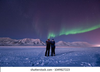 The Polar Arctic Northern Lights Aurora Borealis Sky Star In Norway Svalbard In Longyearbyen City Man People Mountains