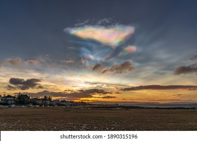 Polar stratospheric clouds and sunrise. Nacreous clouds. Rainbow clouds and the Atlantic Ocean coast - Powered by Shutterstock