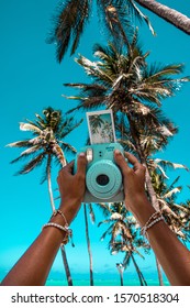 Polaroid Camera And Picture In A Tropical Place