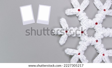 Polaroid retro photo frames isolated on grey background. Real photo template. Three frames. Mockup. Christmas white fluffy snowflake. Winter decoration..