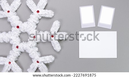 Polaroid retro photo frames isolated on grey background. Real photo template. Three frames. Mockup. Christmas white fluffy snowflake. Winter decoration..