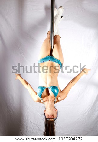 Pole Acrobat demonstrating pole moves