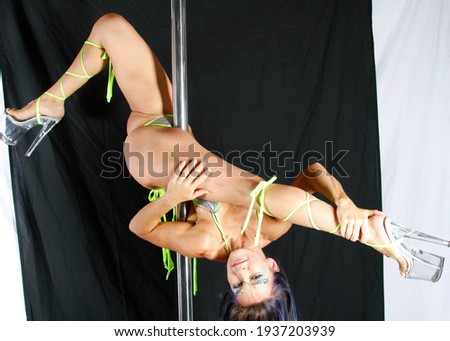 Pole Acrobat displaying moves on a pole