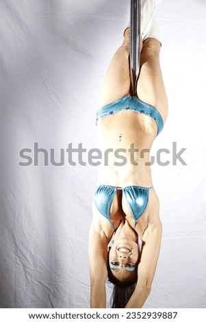 Pole Acrobat doing aerial stunts