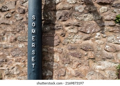 A pole against a stone wall indicates the location as the county of Somerset in south west England.