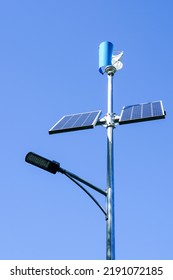 Pole With Innovative LED Street Light Powered By Solar Cells And Small Vertical Wind Generator, Blue Sky Background