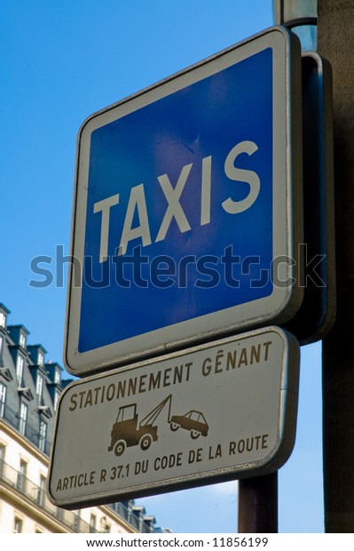 Pole with\
a taxi sign and a no parking warning\
sign