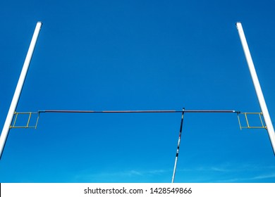 Pole Vault Equipment: Bar, Pole And Pole Vault Standards In Background Blue Sky