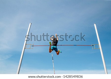 pole vault man athlete knocks bar to fly background blue sky