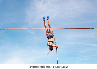 Pole Vault Woman Jumper On Blue Sky Background In Athletics