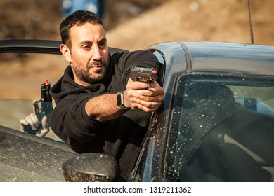 Police Agent And Bodyguard Training Action Gun Shooting From Car. Special Agent Team Weapons Training And Course On Outdoor Shooting Range