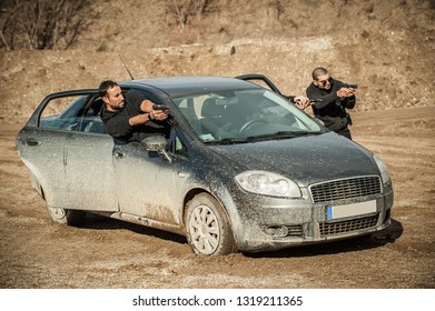 Police Agent And Bodyguard Training Action Gun Shooting From Car. Special Agent Team Weapons Training And Course On Outdoor Shooting Range