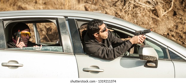 Police Agent And Bodyguard Training Action Gun Shooting From Car. Special Agent Team Weapons Training And Course On Outdoor Shooting Range