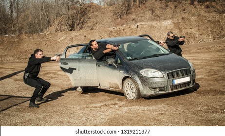 Police Agent And Bodyguard Training Action Gun Shooting From Car. Special Agent Team Weapons Training And Course On Outdoor Shooting Range