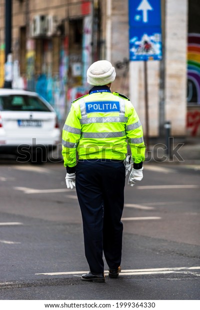 Police agent, Romanian Traffic Police (Politia\
Rutiera) directing traffic during  rush hour in downtown Bucharest,\
Romania, 2021