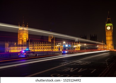 Police, Ambulance Emergency Vehicles At Night On Westminster Bridge By Big Ben, Houses Of Parliament, London, England