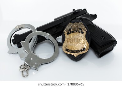 Police Badge, Gun And Handcuffs On White Background