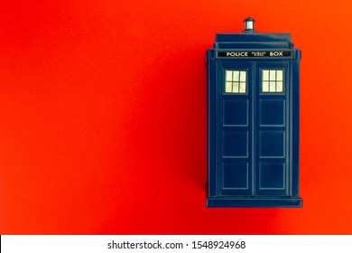 Police call box in front of red background flat lay