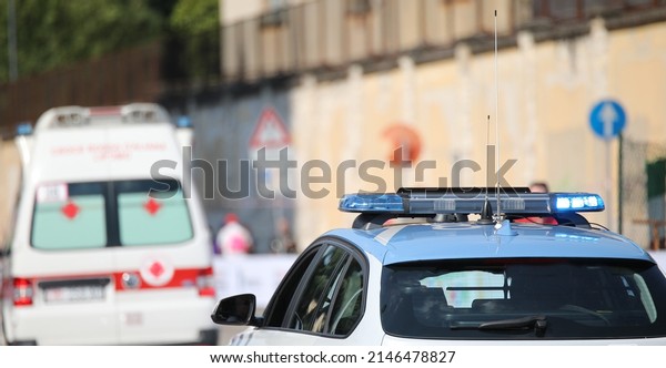 police car with\
blue flashing lights on it while escorting an ambulance to go to\
the hospital after the\
accident