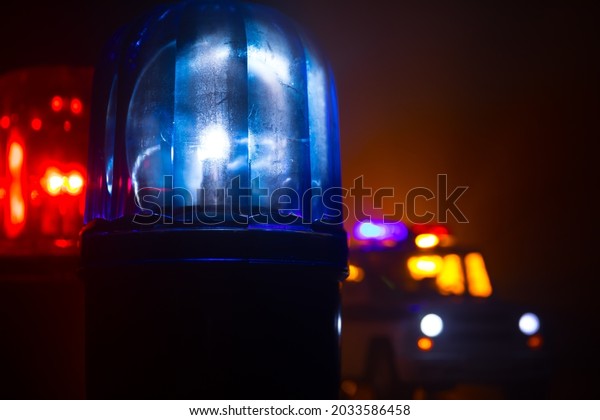 Police car blue and red\
round vintage siren in dark. Rotating retro style police siren.\
Selective focus