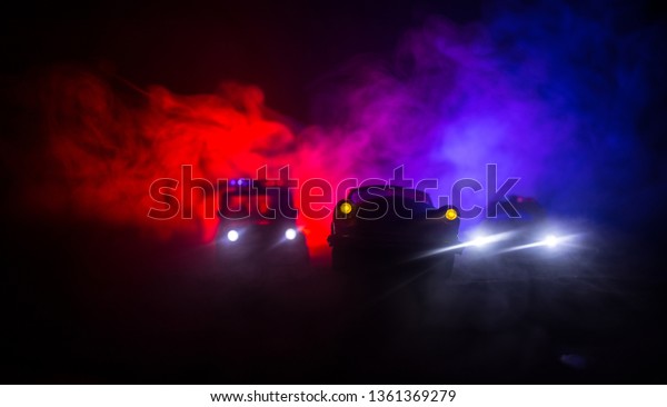 Police car chasing a car at night with fog
background. 911 Emergency response police car speeding to scene of
crime. Selective focus