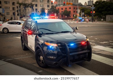 A police car with emergency lights on stopped in an urban environment