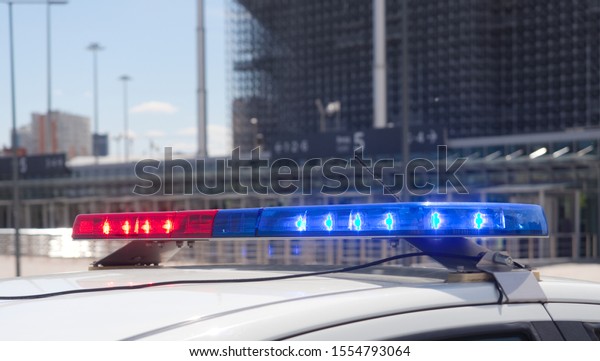 Police car\
with flashing  emergency vehicle\
lighting