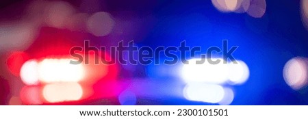 Police car with flashing lights at night
