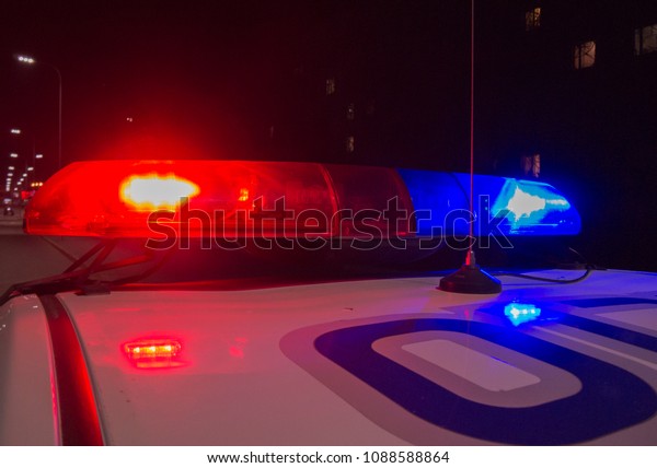 Police car flashing lights in night time,\
crime scene, night patrolling the\
city.	