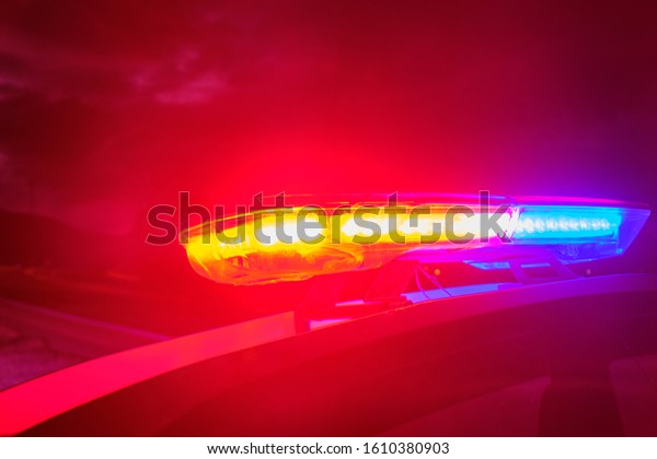 police\
car flashing lights in the night selective\
focus