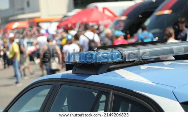 police car with flashing\
lights on it during the escort and demonstration with many people\
in the street