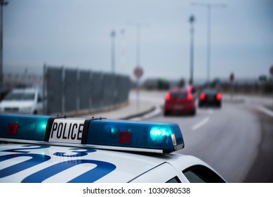 Police car following cars inside a city with motion blur effect. - Shutterstock ID 1030980538