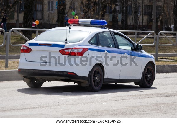 A police car\
isolated on a white\
background.