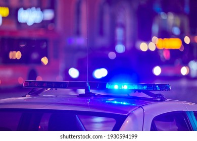 Police car lights at night city street. Red and blue lights. Road traffic accident. Evening patrolling - Shutterstock ID 1930594199