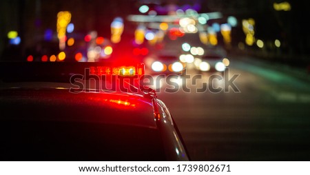 police car lights in night city with selective focus and bokeh