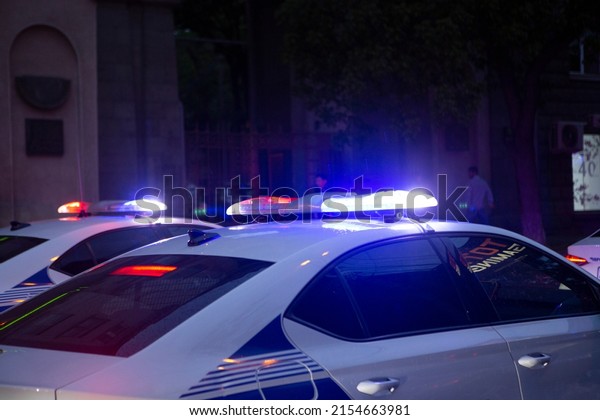 Police car lights at night city street. Red and\
blue lights.