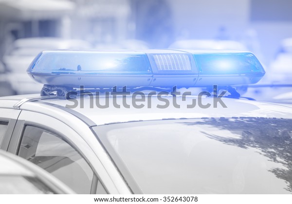 Police car with lights turned\
on.