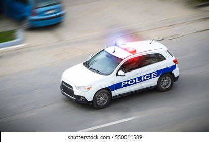 Police Car In Motion Blur With Flashing Lights