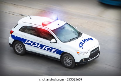 Police Car In Motion Blur With Flashing Lights