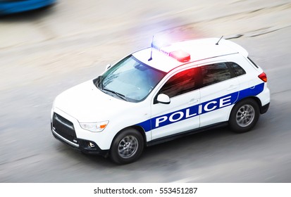 Police Car In Motion Blur With Flashing Lights