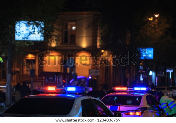 Police car at night in\
city\
