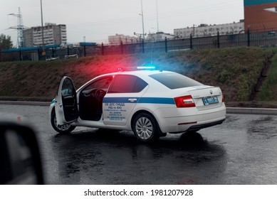 Police Car On The Road With A Flasher On At The Scene Of An Accident. Evening Time Of Day After Rain, Twilight. Moscow, Russia 05.12.2021