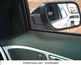 Police Car In Rear View Mirror View From Pulled Car