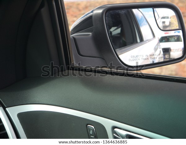Police car\
in rear view mirror view from pulled\
car