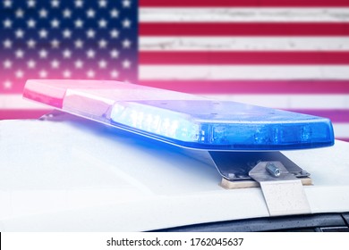 Police car with red and blue lights on a United States of America flag background