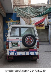 Police Car, In White, Red And Black Colors. Plastic Sheets On The Ceiling. Tire Hanging On The Vehicle. Multan, Pakistan. 04. 10. 2022.